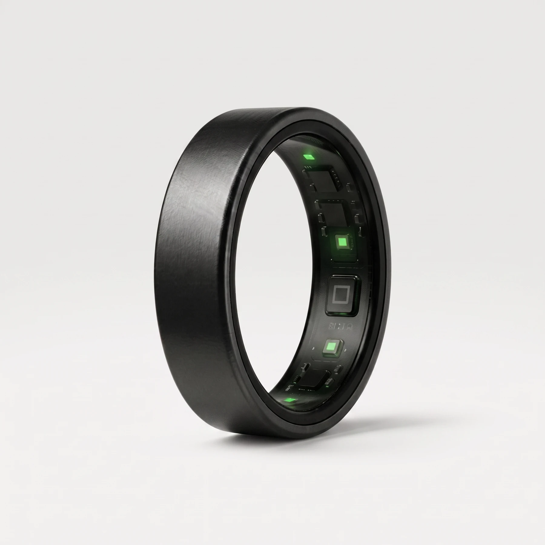 UbiRing in Midnight Black: a brushed graphite titanium band, its inner sensor array lit green through the opening.